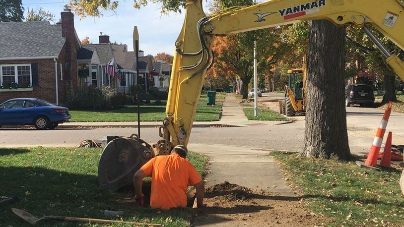 Workers dig up and replace a water main line on Cushing Avenue, off of Shroyer Road in Kettering. KARA DRISCOLL/STAFF