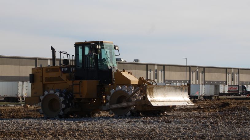 Construction crews work at the site of an estimated $31 million facility near the Dayton International Airport. CORNELIUS FROLIK / STAFF