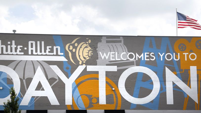 Welcoming commuters to Dayton is a mural spanning the length of the White Allen body shop, 442 N. Main Street. The artwork, a collaboration with local artist Amy Deal and K12 Gallery & TEJAS, celebrates the innovative history of the city. LISA POWELL / STAFF