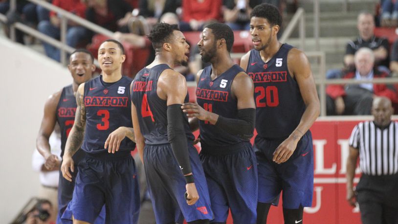 Dayton seniors (left to right) Kendall Pollard, Kyle Davis, Charles Cooke and Scoochie Smith, plus sophomore Xeyrius Williams, react after Smith’s third 3-pointer in overtime against Davidson on Friday, Feb. 24, 2017, at Belk Arena in Davidson, N.C.