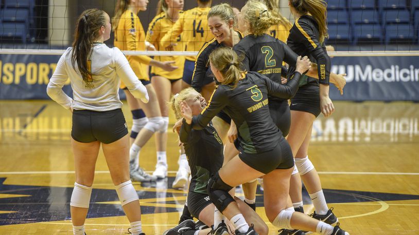 Wright State players celebrate winning a point in a victory over West Virginia on Aug. 25, 2018. CONTRIBUTED