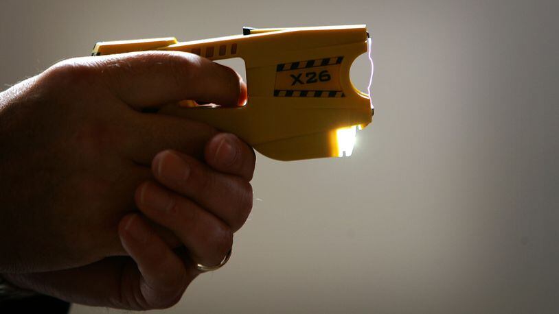 BLACKPOOL, UNITED KINGDOM - MAY 16:  A representative from Taser International fires the companies latest X26 stun gun during the Police Federation Conference at Winter Gardens on May 16, 2007 in Blackpool, England. British Home Secretary John Reid announced today that more Taser guns could be deployed on the streets of the UK by frontline police officers. The Taser's which stun a person with up to 50,000 volts, and can currently only be carried by armed response officers have some under harsh criticism from Amnesty International  who claim more than 70 deaths in Canada and America have been linked to the weapon.  (Photo by Christopher Furlong/Getty Images)