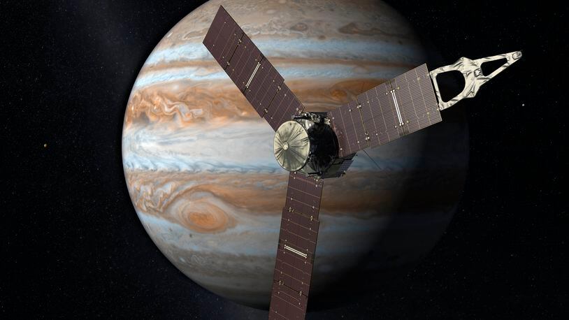 This artist's rendering provided by NASA and JPL-Caltech shows the Juno spacecraft above the planet Jupiter.