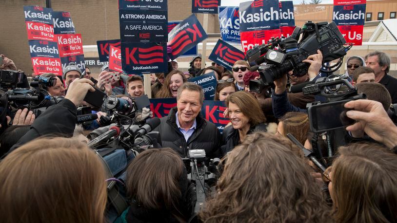 Ohio Gov. John Kasich, a Republican presidential hopeful, and with his wife, Karen Waldbillig Kasich, talk to reporters outside a polling station in Concord, N.H., Feb. 9, 2016. Voters will pour into their polling places in New Hampshire Tuesday for the first primary election of the 2016 presidential campaign. (Stephen Crowley/The New York Times)