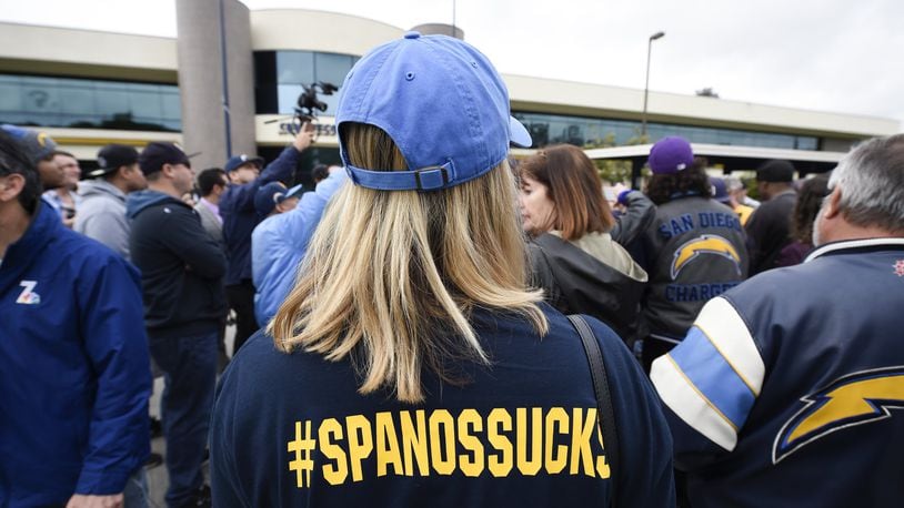 A fan mocks team owner Dean Spanos on Thursday after learning the San Diego Chargers are moving to Los Angeles. Other fans burned team gear, reminiscent of when the Cleveland Browns left for Baltimore. (AP Photo/Denis Poroy)