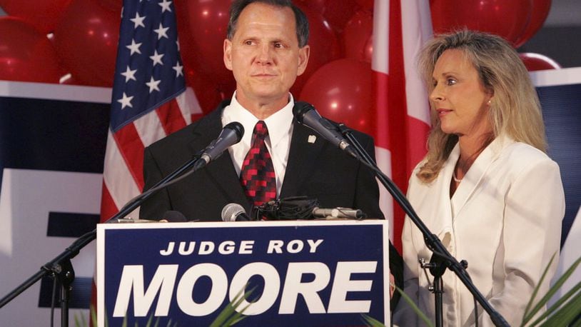 FILE - In this Tuesday, June 6, 2006 file photo, Judge Roy Moore stands with his wife, Kayla, after conceding the governor’s race to Gov. Bob Riley, in Gadsden, Ala. (AP Photo/Butch Dill)