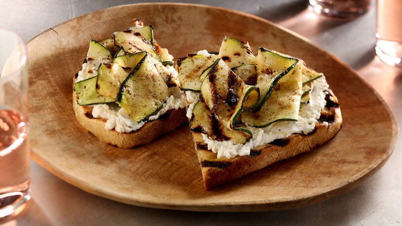 For a light summery lunch or simple appetizer, grill up some rustic bread, slather it with garlic-oil doused ricotta and top with grilled zucchini ribbons. (Michael Tercha/Chicago Tribune/TNS)