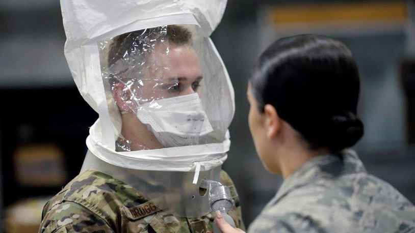 Airman 1st Class Nicholas Grogg (left) followed directions from Airman 1st Class Abigail Pack, 88th Aerospace Medicine Squadron, during testing of the mask fit. (U.S. Air Force photo/Ty Greenlees)