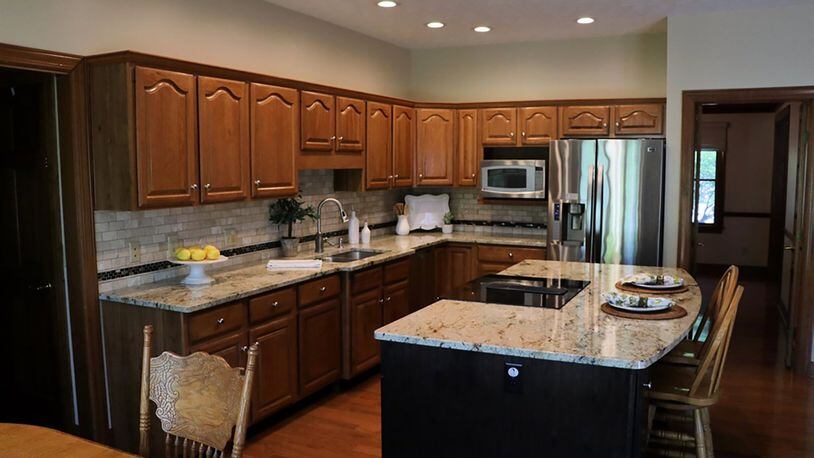 As the hub of the gathering space, the kitchen has an elegant look with updated granite countertops and stainless-steel appliances.