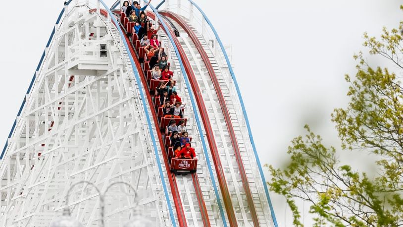 Visitors ride The Racer after Kings Island held an opening ceremony and ribbon cutting Friday, April 29, 2022 in celebration of their 50th Anniversary. NICK GRAHAM/STAFF