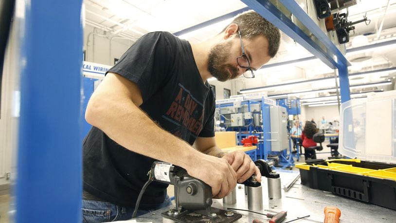 Zac Cox, 29, was completing course work in Sinclair’s Manufacturing Solutions program to improve his skills as a maintenance technician for his employer, F&P America Manufacturing in Troy in this file photo.
