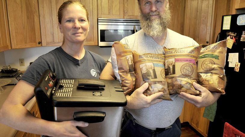 Jeanne Rue holds the small fryer she and her husband, Matt, started making their potato chips with. Two years later, they are selling Rue Farms Rustic Patoto Chips at Whole Foods and several other area grocery stores. Bill Lackey/Staff