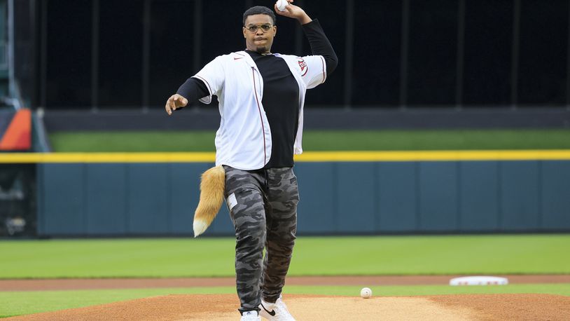 Cincinnati Bengals' Orlando Brown Jr. throws the ceremonial first pitch prior to a baseball game between the Texas Rangers and the Cincinnati Reds in Cincinnati, Tuesday, April 25, 2023. (AP Photo/Aaron Doster)