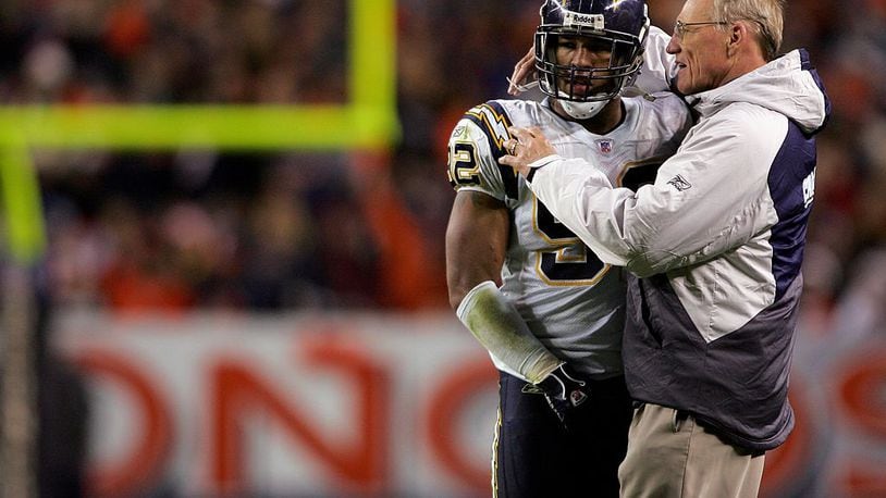 Head coach Marty Schottenheimer of the San Diego Chargers talks with linebacker Shaun Phillips #92 as the Chargers defeated the Denver Broncos 35-27 during NFL action on November 19, 2006 at Invesco Field at Mile High in Denver, Colorado. (Photo by Doug Pensinger/Getty Images)