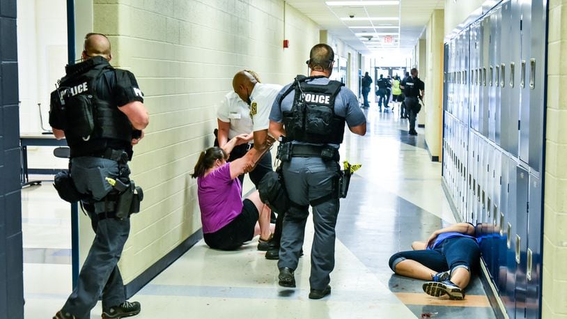 Police, fire and other agencies held a SWAT training drill at Hamilton High School last summer, mirroring what might happen in an actual school emergency. NICK GRAHAM/STAFF