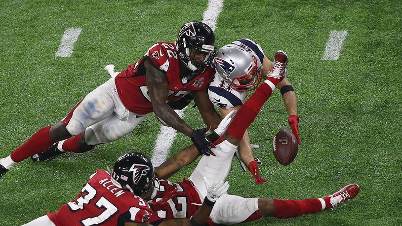 HOUSTON, TX - FEBRUARY 05: Julian Edelman #11 of the New England Patriots makes a 23 yard catch in the fourth quarter against Ricardo Allen #37, Robert Alford #23 and Keanu Neal #22 of the Atlanta Falcons during Super Bowl 51 at NRG Stadium on February 5, 2017 in Houston, Texas. (Photo by Ezra Shaw/Getty Images)