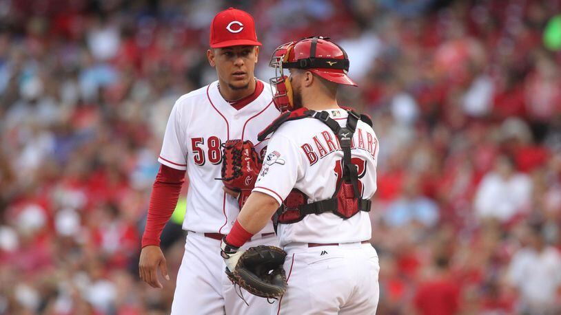 Reds starter Luis Castillo talks to catcher Tucker Barnhart during a game against the Brewers in June 2017 at Great American Ball Park in Cincinnati.