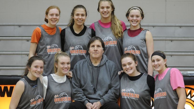 Tim Gabbard is in his 39th season coaching the Waynesville High School girls basketball team. Key members of the unbeaten Spartans are, front (left) Hannah Gill, Carli Brown, Gabbard, Kenzie Purkey and Leah Butterbaugh. Back (left) Kenna Harvey, Lynzie Hartshorn, Marcella Sizer and Rachel Murray. MARC PENDLETON / STAFF