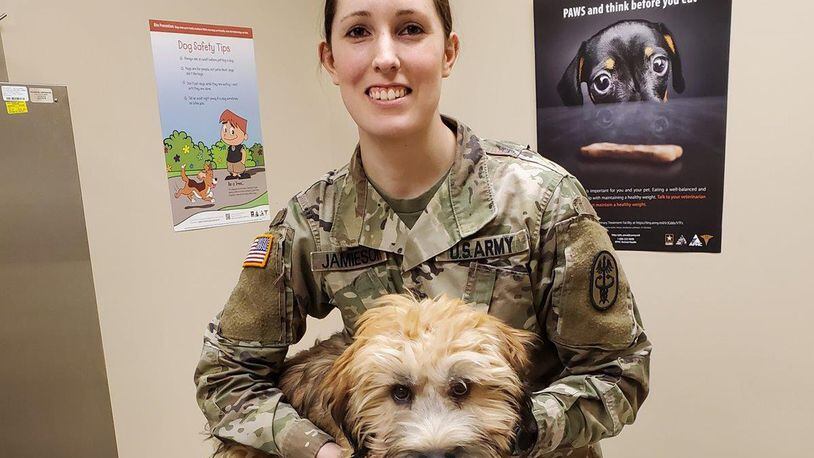 Army Sgt. Brianna Jamieson, NCO in charge of the Wright-Patterson Veterinary Treatment Facility, evaluates Dodger during a routine appointment. (Courtesy photo)