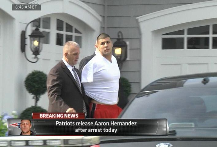 Police escort Aaron Hernandez from his home in handcuffs