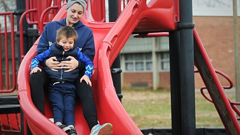 Mae Salmons and her son Leo Sommers took advantage of the warm weather this winter to play outside at C. F. Holliday Elementary school in West Carrollton. STAFF/MARSHALL GORBY