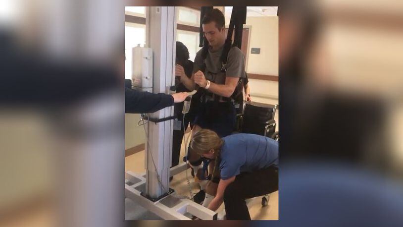 Alexander (Alex) Cash at Atrium Medical Center rehab, using a Lifegait machine with and his inpatient physical therapist, Melissa Kahlig Wolf in January 2018. CONTRIBUTED