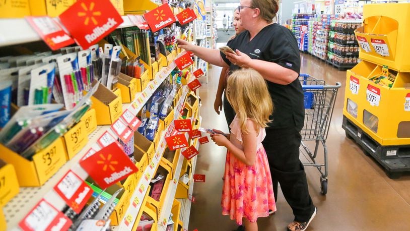Brandy Cox shops for school supplies with her children Makaila Cox and Kara Rich, at the Walmart in West Chester, Wednesday, July 26, 2017. GREG LYNCH / STAFF