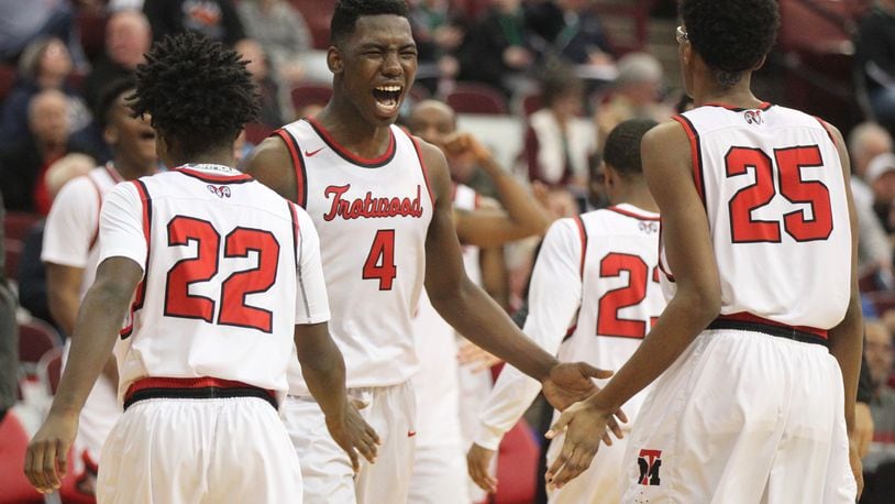 Trotwood-Madison’s Myles Belyeu (4) celebrates a victory against Meadowbrook in a Division II state semifinal on Friday, March 23, 2018, at the Schottenstein Center in Columbus. David Jablonski/Staff