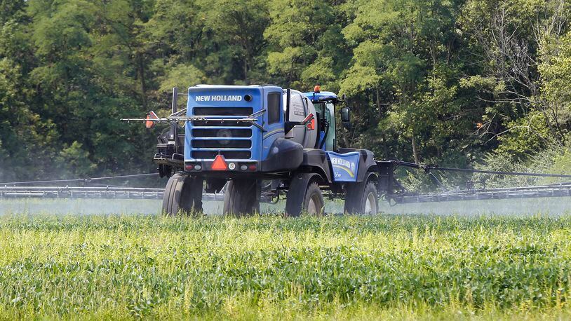 A farmer in Greene County sprays a soybean field along Jasper Road near Jamestown. TY GREENLEES / STAFF