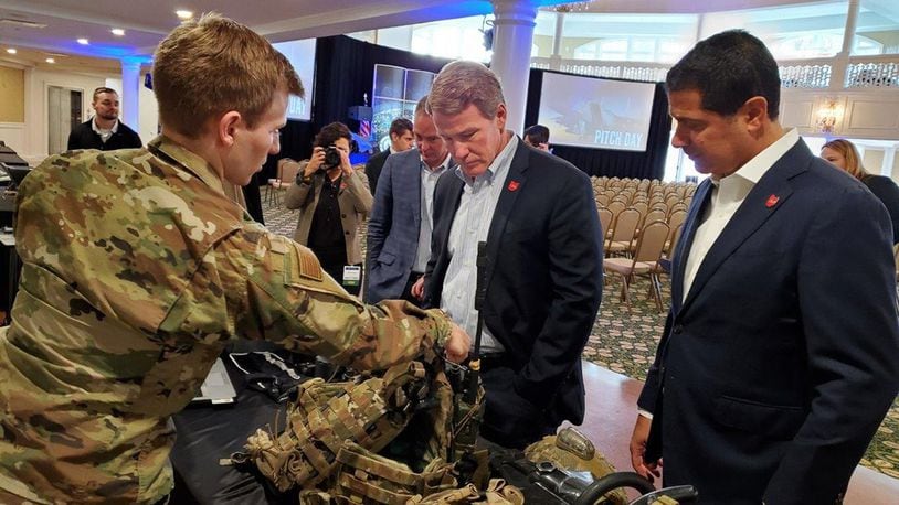 1st Lt Patrick Assef (left), a special warfare mechanical engineer with the Air Force Research Laboratory, explains several Air Force programs to Lt. Gov. Jon Husted (center) of Ohio during the Air Force Life Cycle Management Center’s Pitch Day Nov.13-14, 2019.