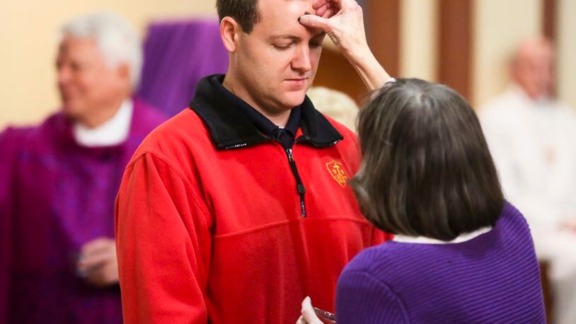 FILE Andy Guiler. of Middletown, receives ashes during the Ash Wednesday service at Holy Trinity Catholic Church in Middletown. GREG LYNCH / STAFF