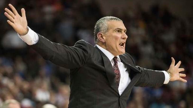 South Carolina head coach Frank Martin communicates with an official during the second half of an NCAA college basketball game against Florida, Wednesday, Jan. 18, 2017, in Columbia, S.C. South Carolina defeated Florida 57-53. (AP Photo/Sean Rayford)