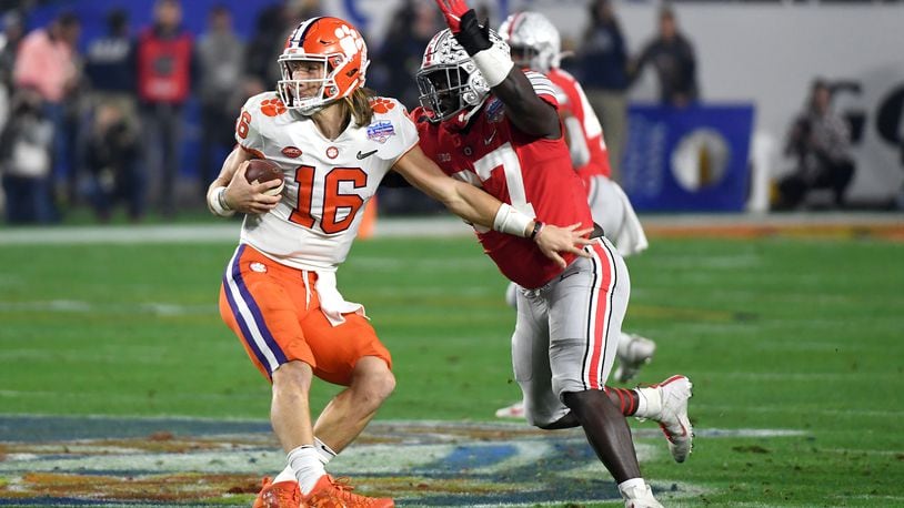 GLENDALE, ARIZONA - DECEMBER 28: Trevor Lawrence #16 of the Clemson Tigers is hit by Robert Landers #67 of the Ohio State Buckeyes in the first half during the College Football Playoff Semifinal at the PlayStation Fiesta Bowl at State Farm Stadium on December 28, 2019 in Glendale, Arizona. (Photo by Norm Hall/Getty Images)
