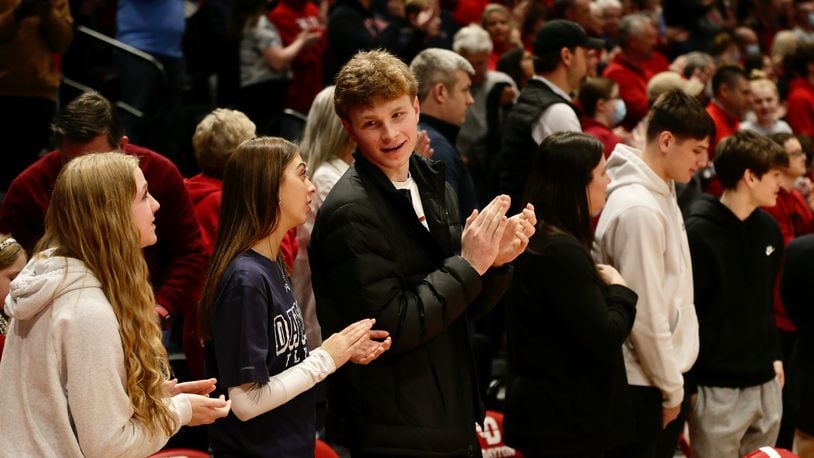 Oakwood junior Will Maxwell, third from left, and Lakota West junior Nathan Dudukovich, second from right, watch Dayton's game against Duquesne on Wednesday, Feb. 9, 2022, at UD Arena. David Jablonski/Staff