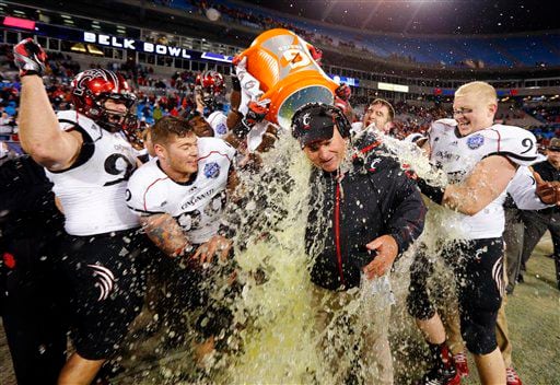 Cincinnati head coach Steve Stripling, center, gets doused by players in the closing seconds of the Belk Bowl NCAA college football game against Duke in Charlotte, N.C.