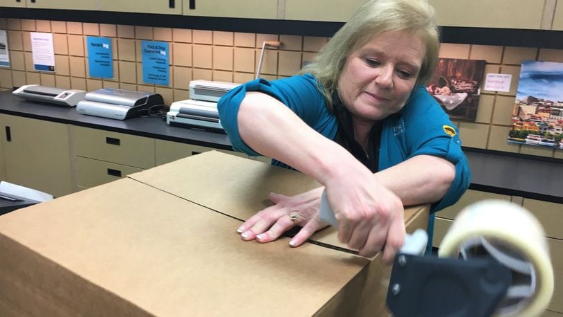 Deb Cain, owner of the UPS store in Springboro, gets a box ready to ship. Shipping deadlines for UPS begin Dec. 13 but other deadlines begin as early as Monday. STAFF PHOTO / HOLLY SHIVELY