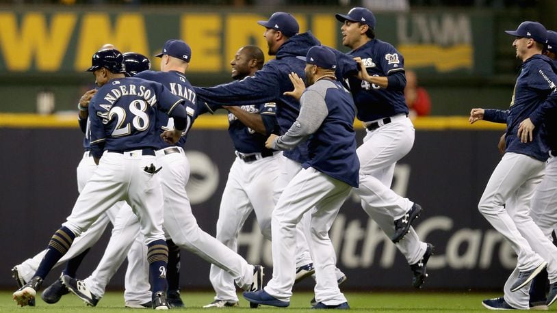 MILWAUKEE, WI - OCTOBER 04:  The Milwaukee Brewers celebrate winning Game One of the National League Division Series game 3-2 over the Colorado Rockies after Mike Moustakas #18 hits a a walk off single at Miller Park on October 4, 2018 in Milwaukee, Wisconsin.  (Photo by Dylan Buell/Getty Images)