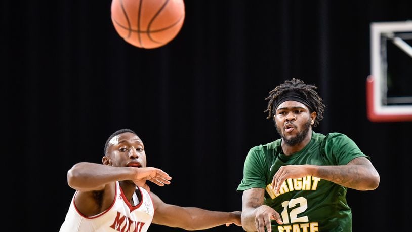 Wright State’s Tye Wilburn makes a pass as he is defended by Miami’s Isaiah Coleman-Lands during their game Tuesday, Nov. 14 at Millett Hall on the Miami University Campus in Oxford. The Miami University Redhawks basketball team defeated the Wright State Raiders 73-67 in overtime. NICK GRAHAM/STAFF