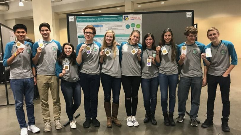 The Air Force Research Laboratory-Carroll High School iGEM team displays their gold medals after the international iGEM competition in Boston Nov. 13. (U.S. Air Force photo/Richard Eldridge)