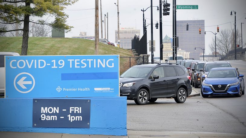 Cars waiting in line for COVID testing at the old Montgomery County fairgrounds stretched down N. Main Street to the ER entrance of Miami Valley Hospital Monday morning.