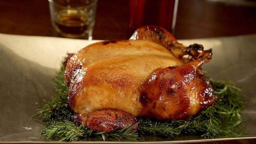 Distilled liquors such as bourbon can enhance the flavor of food, like this honey-bourbon roast chicken. (Kirk McKoy/Los Angeles Times/TNS)