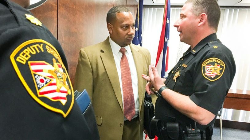 Montgomery County Administrator Michael Colbert and Montgomery County Sheriff Rob Streck speak after a meeting in which county commissioners approved moving forward with a jail expansion study phase. CHRIS STEWART / STAFF
