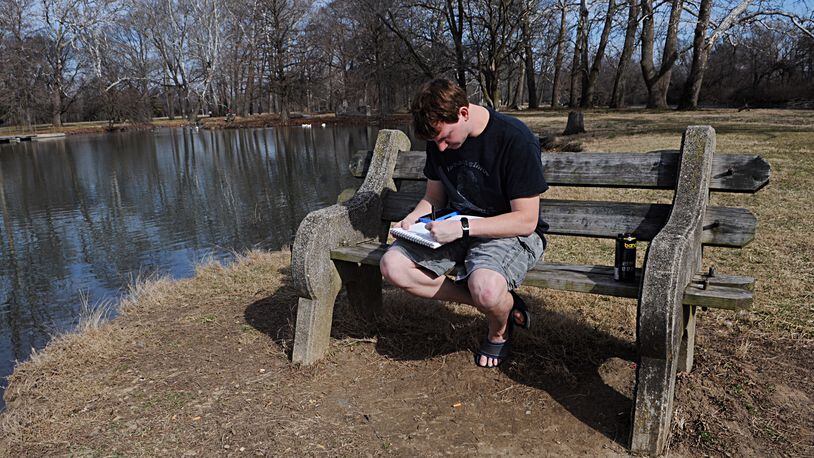 Bryan Turner, takes advantage of the nice weather Monday to come out and sit by one of the ponds at Eastwood Park. MARSHALL GORBY/STAFF