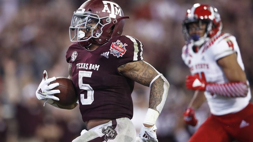 JACKSONVILLE, FL - DECEMBER 31: Trayveon Williams #5 of the Texas A&M Aggies runs for a 17-yard touchdown against the North Carolina State Wolfpack in the third quarter of the TaxSlayer Gator Bowl at TIAA Bank Field on December 31, 2018 in Jacksonville, Florida. Texas A&M won 52-13. (Photo by Joe Robbins/Getty Images)