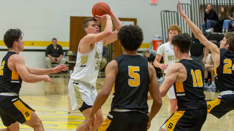 Botkins senior Jacob Pleiman shots over the Shawnee defense Sunday at Centerville. Pleiman recently scored his 1000th point. Jeff Gilbert/CONTRIBUTED