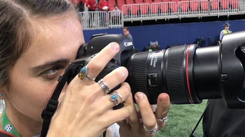 Chamberlain Smith, a University of Georgia intern who was injured photographing a game, was back on the sidelines Saturday.