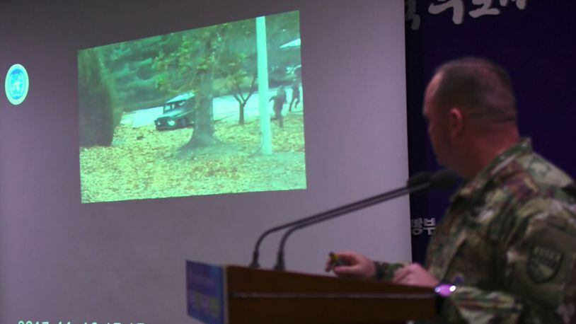 United Nations Command spokesman Colonel Chad G. Carroll shows a surveillance TV footage containing the moment of defection of a North Korean soldier.
