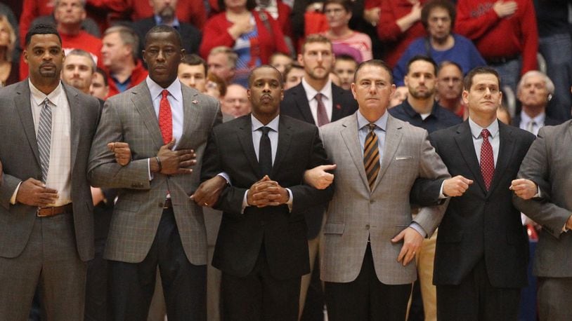 Dayton coaches stand for the national anthem before a game against Purdue Fort Wayne on Friday, Nov. 16, 2018, at UD Arena.