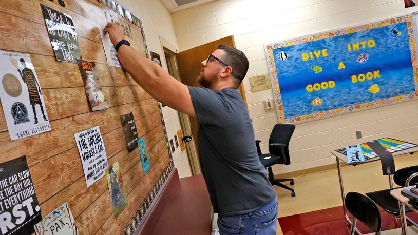 Paul Merkle, a sixth grade English/Language Arts teacher at Tecumseh Middle School, gets his classroom ready Friday, August 11, 2023. Classes start at Tecumseh on Wednesday, August 16. BILL LACKEY/STAFF
