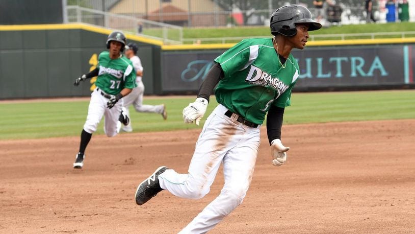 Andy Sugilio (front) and Dragons teammate Lorenzo Cedrola round the bases during Sunday’s 9-5 loss to visiting Lansing. DRAGONS CONTRIBUTED PHOTO